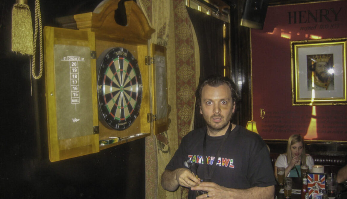 web What are you looking at Zane Lamprey seems startled that a photographer is interrupting his darts game at Ye Olde King’s Head Pub